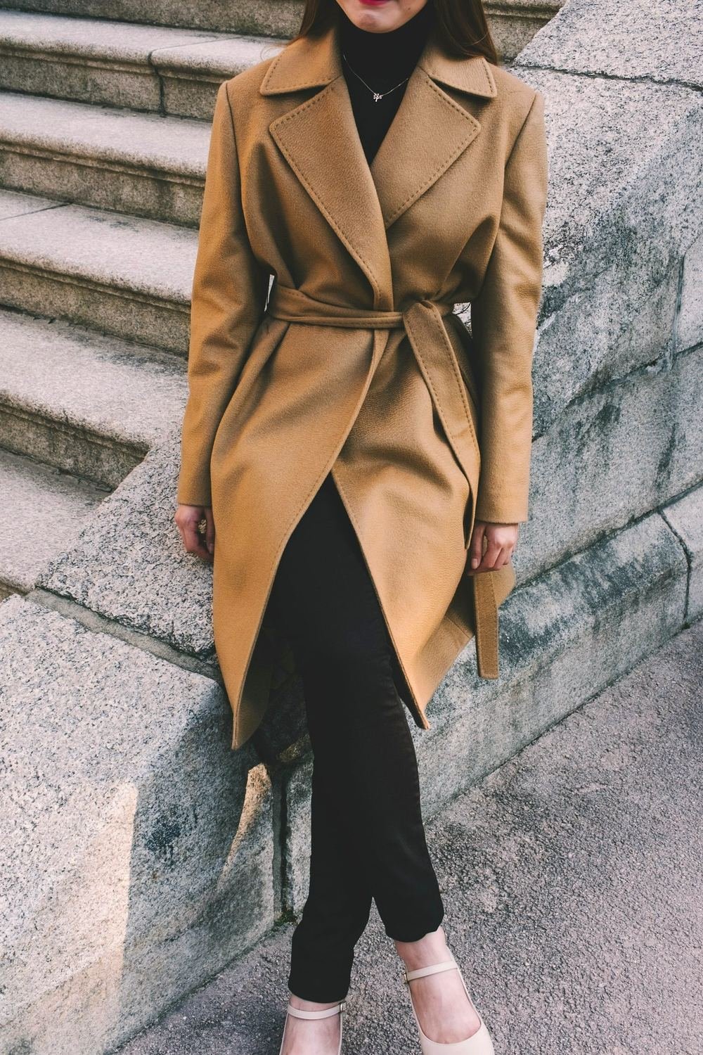 Camel wrap coat over a black column dress