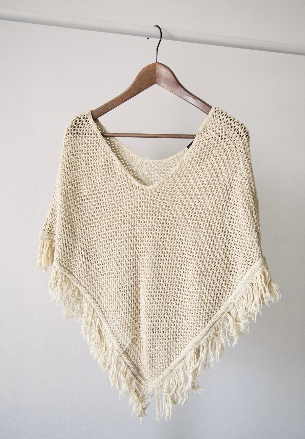 Cream open-weave poncho with hand-knotted fringe